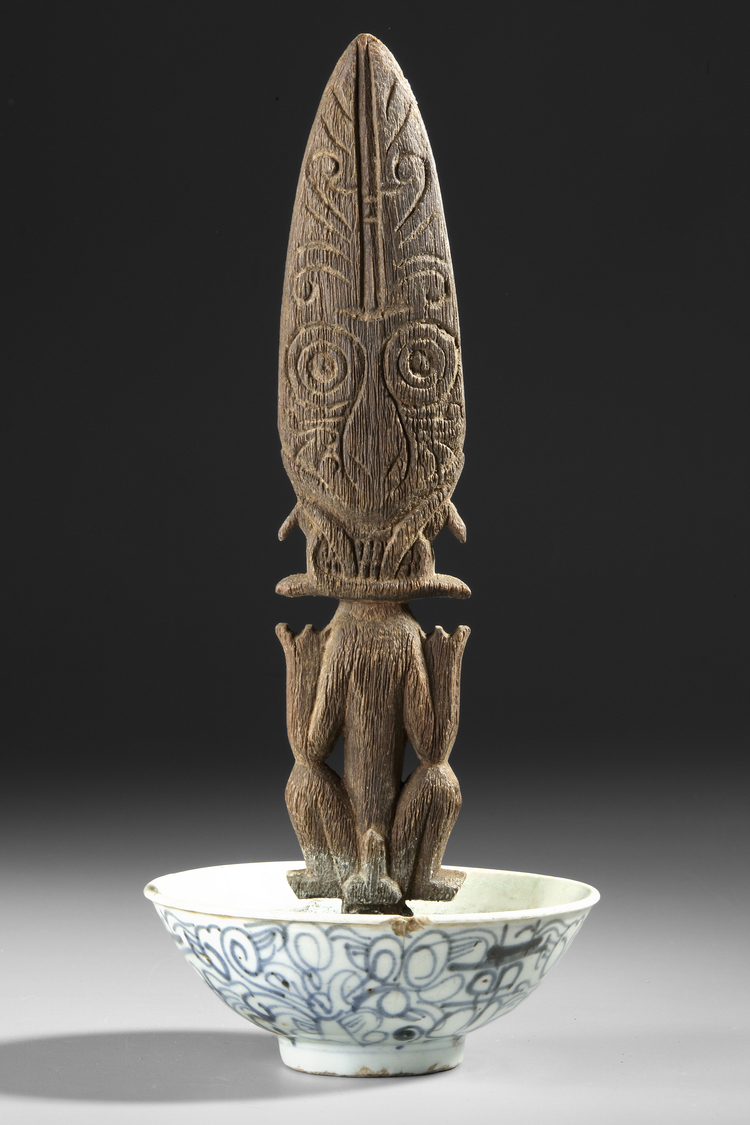 Borneo Dayak Hampatong figure in a 19th century copy of a Song bowl.