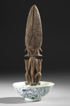 Borneo Dayak Hampatong figure in a 19th century copy of a Song bowl.