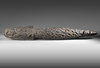 Large Asmat neckroll with ancestor heads, praying mantis and other headhunting motifs.