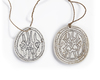 Two Solomon Islands Tridacna shell disc pendants depicting a stylized Frigatebird. Probably Malaita island.