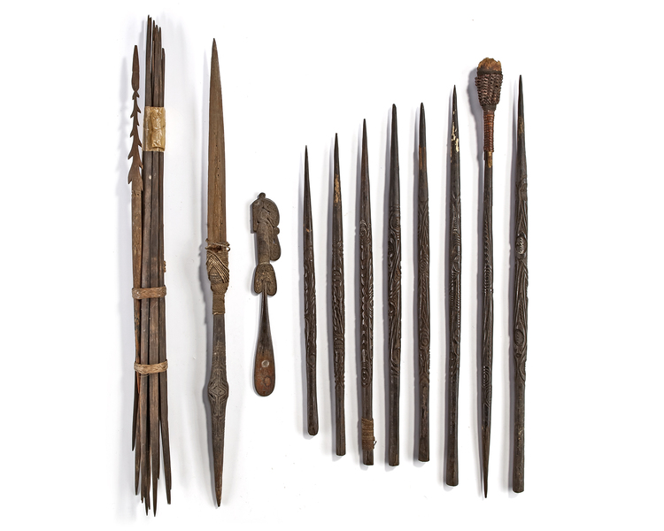 Lot of Sentani arrow heads and a Trobriands spatula.