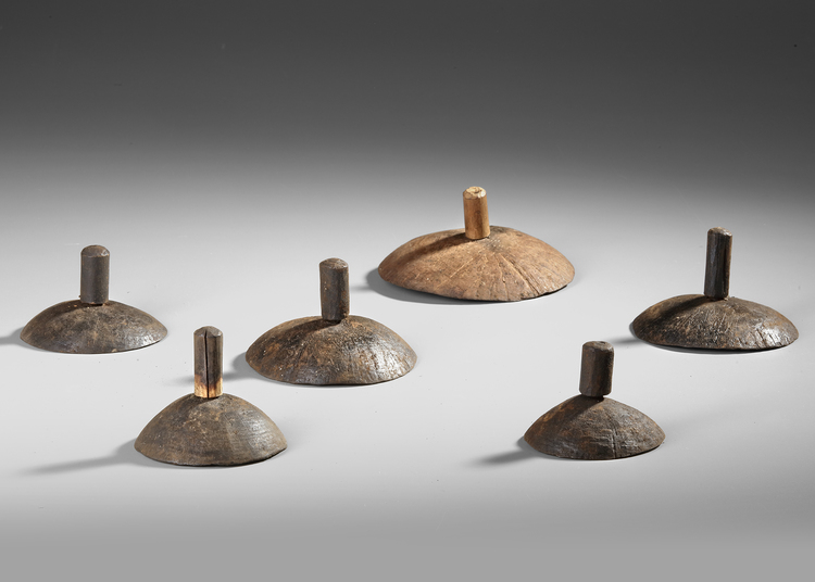 Six old and well used Anelam spinning tops. Ceremonial toys.