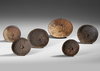 Six old and well used Anelam spinning tops. Ceremonial toys.