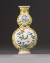 A Chinese yellow-ground famille rose double gourd wall vase