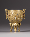 A Chinese gilt bronze inlaid tripod cup