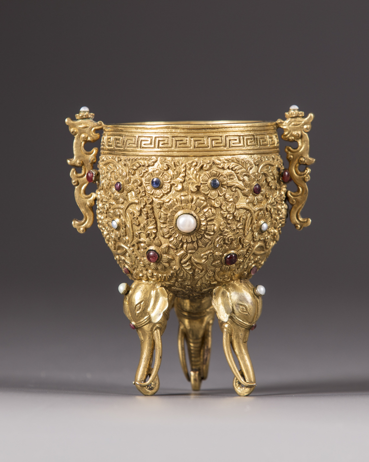 A Chinese gilt bronze inlaid tripod cup