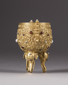 A Chinese gilt bronze inlaid tripod cup