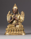 A parcel-gilt bronze figure of a Lama