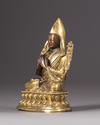 A parcel-gilt bronze figure of a Lama