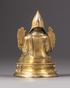 A parcel-gilt bronze figure of a Lama