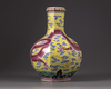 A Chinese yellow-ground octagonal famille rose 'dragon' bottle vase