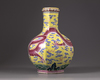 A Chinese yellow-ground octagonal famille rose 'dragon' bottle vase