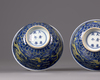 A pair of Chinese yellow-enamelled blue and white 'dragon' bowls