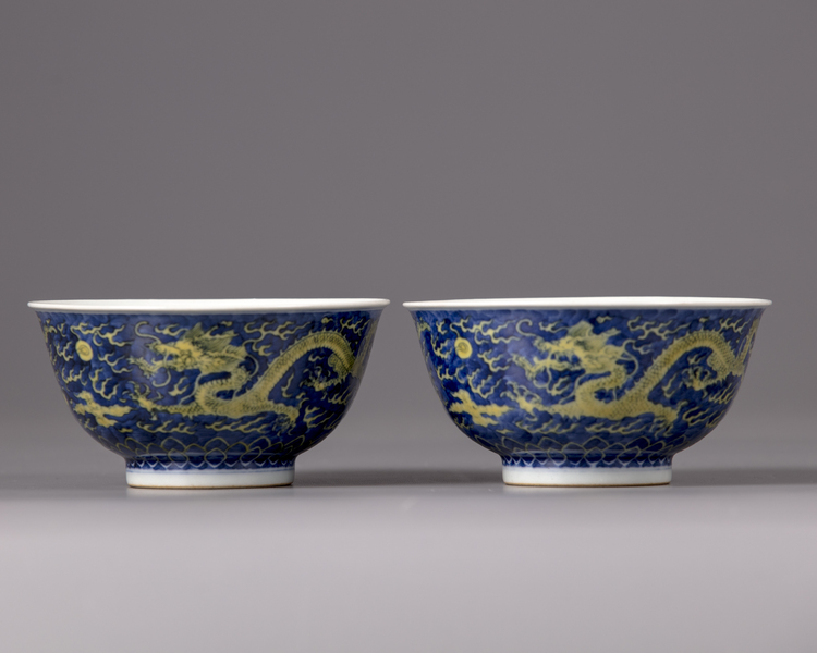 A pair of Chinese yellow-enamelled blue and white 'dragon' bowls