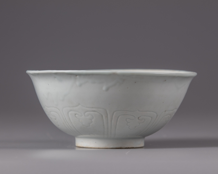 A Chinese Shufu-style white-glazed moulded 'dragon' bowl