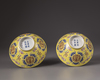 A pair of Chinese yellow-ground famille rose bowls