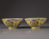 A pair of Chinese yellow-ground famille rose bowls