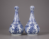 A pair of Chinese moulded blue and white 'Kraak' garlic neck vases