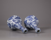 A pair of Chinese moulded blue and white 'Kraak' garlic neck vases