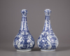 A pair of Chinese moulded blue and white 'Kraak' garlic neck vases