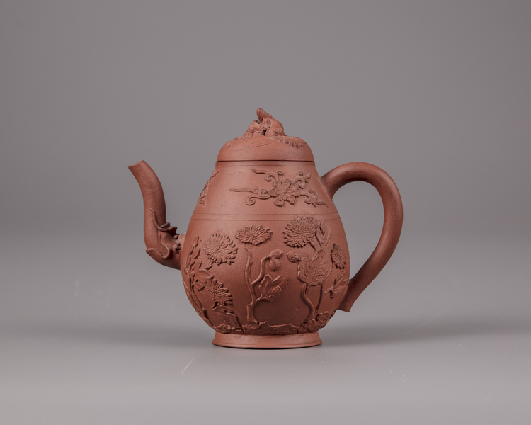 A Chinese yixing floral appliqué teapot and cover