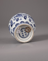 A Chinese blue and white jar with a copper oil lamp cover