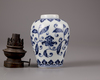 A Chinese blue and white jar with a copper oil lamp cover