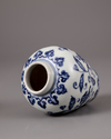 A Chinese blue and white jar with a copper oil lamp cover