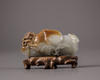 A Chinese white and russet jade 'Three Abundances' carving