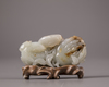 A Chinese white and russet jade 'Three Abundances' carving