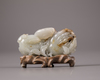 A Chinese white and russet jade 'Three Abundances' carving