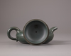 A Chinese green-clay yixing teapot and cover