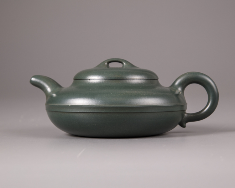 A Chinese green-clay yixing teapot and cover