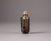 A Chinese smokey-quartz hexagonal inscribed snuff bottle
