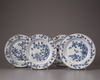 Four blue and white plates