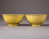A pair of Chinese yellow-glazed ‘dragon’ bowls