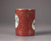 A Chinese coral-red ground famille rose brush pot