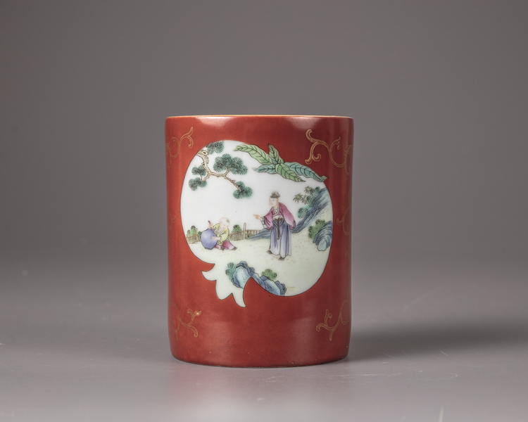 A Chinese coral-red ground famille rose brush pot