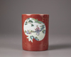 A Chinese coral-red ground famille rose brush pot