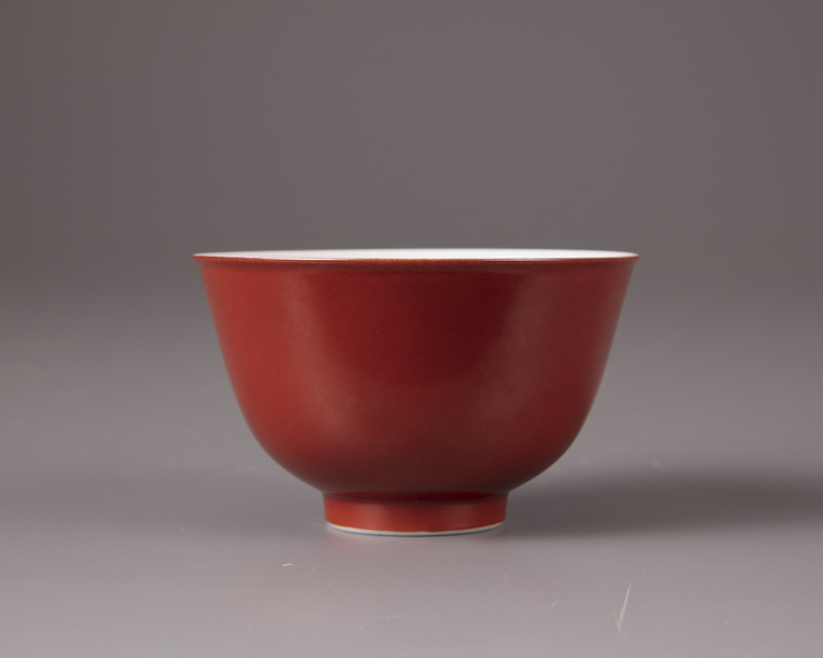 A coral-red glazed bowl