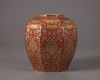 A coral-red ground gilt floral-decorated jar