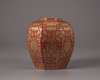 A coral-red ground gilt floral-decorated jar