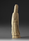 A Chinese ivory carving of a standing scholar