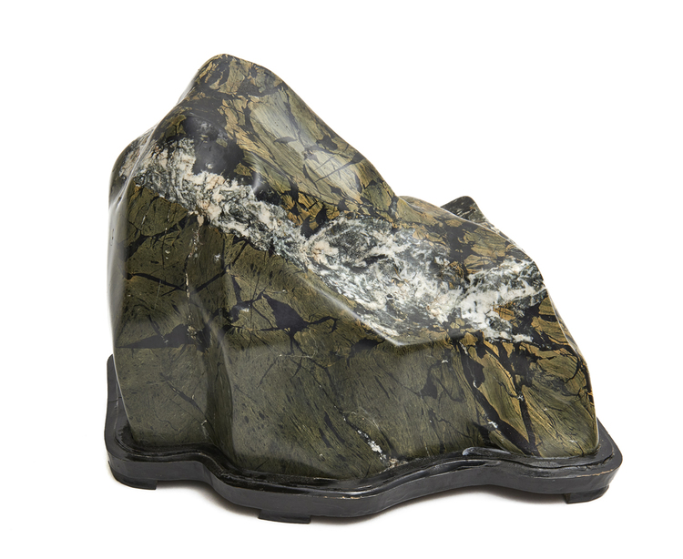 Green-grey mountain-shaped suiseki-stone on a black wooden base