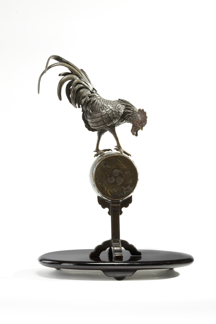 A Japanese figure of a rooster on a stand