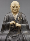 An important and very large painted wooden sculpture of a monk