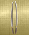 A short Japanese sword (wakizashi) with a black lacquered scabbard (saya) and a kurigata with a cord