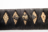A short Japanese sword (wakizashi) with a black lacquered scabbard (saya) and a kurigata with a cord