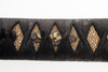 A short Japanese sword (wakizashi) with a black lacquered scabbard (saya) and a kurigata with a cord