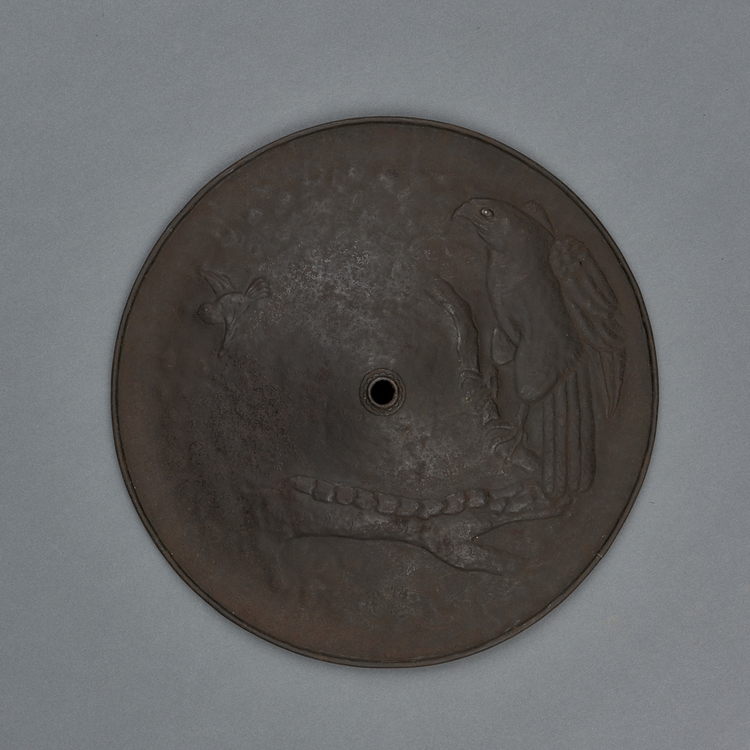A extremely rare flat metal samurai hat (ichimonji jingasa) with a relief depicting a hawk perched in a tree watching a bird